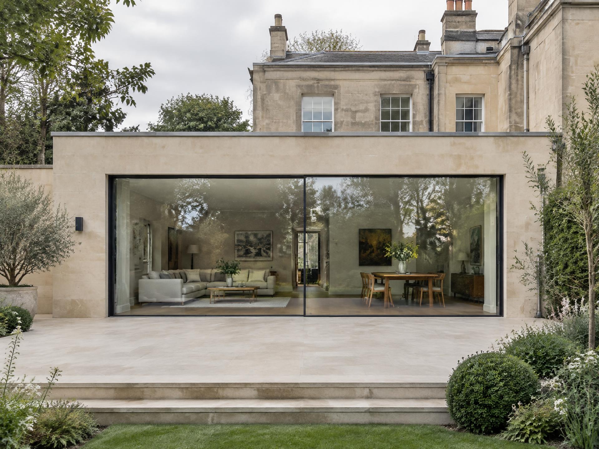Illustrative concept of a contemporary British residential extension with slim sliding glazing, a concealed head, recessed jambs and a neat threshold